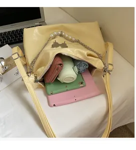 Interior view of spacious yellow tote bag showing storage for tablet, umbrella, and wallet