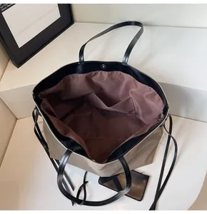 Macro view of canvas tote bag interior with dual slip pockets and magnetic closure