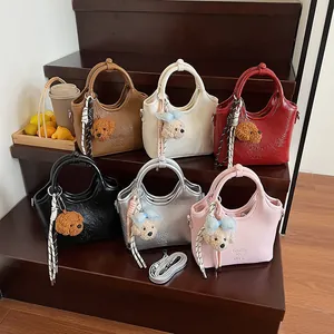 Schicke Leder-Eimertaschen in sechs Farben mit Bärenanhängern und Schultergurten