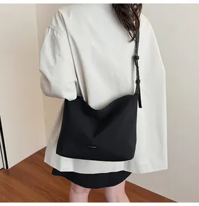 Black hobo bucket bag showing durable high-density nylon fabric and adjustable strap