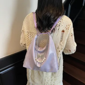 Purple wrinkled patent leather tote backpack with pearls, chains and butterfly charms