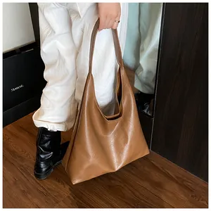Detailed view of a brown vintage leather hobo bag with wide strap for daily commute