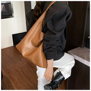 Detailed view of caramel brown tote bag showing supple leather texture and large capacity
