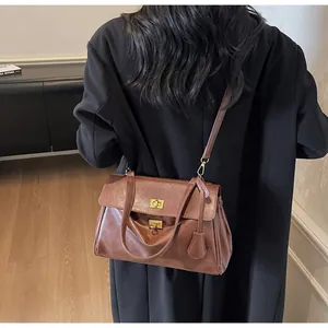 Brown leather tote bag worn as a shoulder bag showing stylish retro commute design