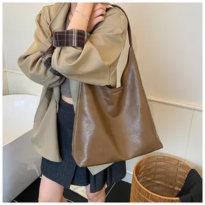 Detail of caramel brown PU leather hobo tote showing large capacity and lychee texture