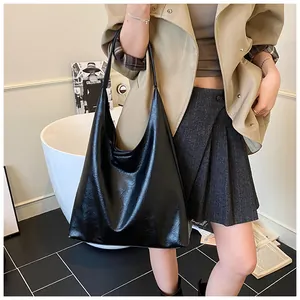 Lifestyle shot of black large capacity hobo tote bag with retro pleated leather texture