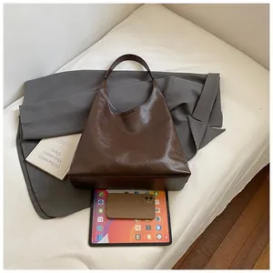 Detailed interior storage capacity of vintage dark brown faux leather tote bag