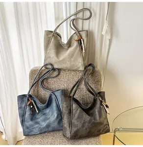 Detailed texture of retro oversized tote bags in three colors with wooden bead charms