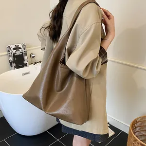 Large brown leather tote bag for women, vintage style commuter shoulder bag shown on model