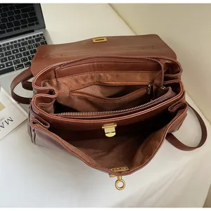 Top view of brown leather tote showing spacious interior, gold twist lock and inner pockets