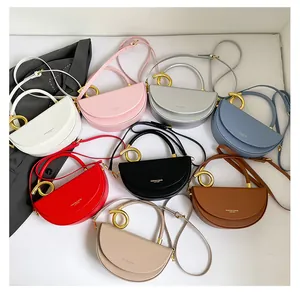 Top view of saddle bags in eight colors with golden metal ring handles and leather straps
