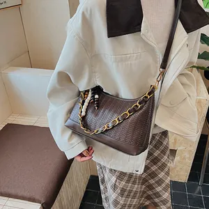 Sac seau marron foncé tressé avec chaîne dorée et breloque en perles colorées