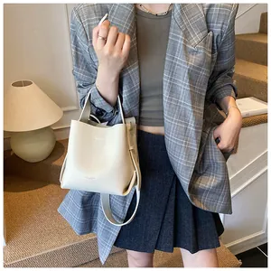 Close-up of cream lychee texture bucket bag with SOSO & BAG branding on the base