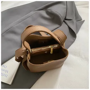 Detailed interior of brown lychee grain bucket bag with zipper pocket and magnetic closure