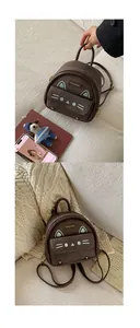 Vue détaillée de la broderie chat et du cuir marron texturé sur le mini sac à dos