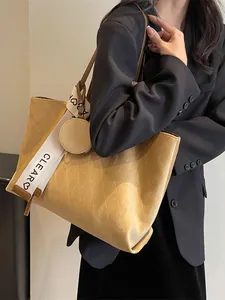 Large khaki tote bag with diamond texture and lettered canvas strap for women