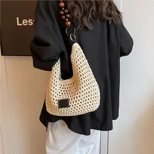 Beige crochet shoulder bag with wooden bead strap and openwork mesh knit detail