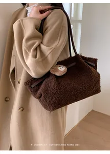 Detail of dark brown plush tote bag with bear charm and leather shoulder strap