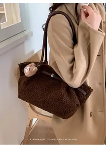 Brown teddy fleece tote bag with leather straps and bear charm on wool coat