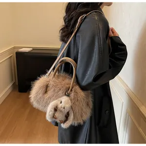 Plush light brown shoulder bag with twin handles and a cute bunny charm detail