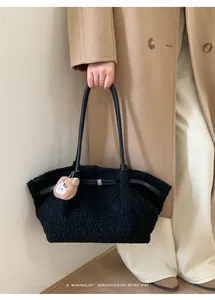 Detail of black faux fur tote bag with leather straps and a cute brown bear pendant