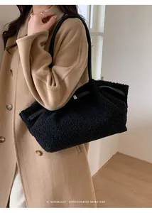Detail view of black plush shoulder bag with leather strap and silver metal buckle