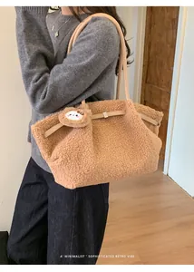 Detailed view of camel faux shearling tote bag with leather straps and cute charm