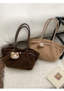 Detail of plush lamb wool tote bags with leather straps and cute bear charms