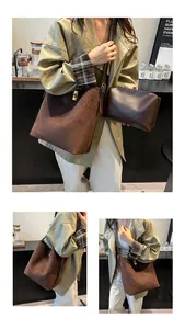 Detail of vintage suede bucket bag with gold twist lock and matching inner pouch