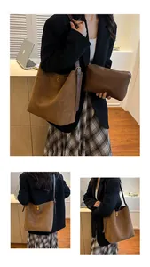 Detail view of brown suede bucket tote bag and matching inner pouch with gold hardware