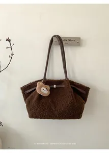 Macro detail of brown faux fur tote bag with leather straps and a cute plush bear charm