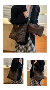 Detailed view of leopard print bucket tote bag with a brown clutch and metal turn-lock