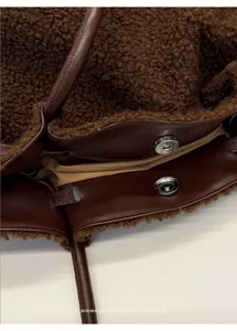 Close-up of fluffy dark brown fleece tote bag with premium leather trim and magnetic closure