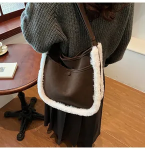 Detail of dark brown faux fur trim tote bag shown in a warm indoor lifestyle setting