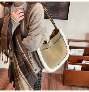 Close-up of green faux suede bucket bag with white plush trim worn over the shoulder