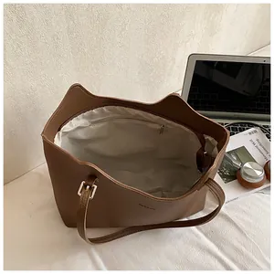 Macro view of brown cat-ear tote bag interior with zipper pocket and adjustable strap