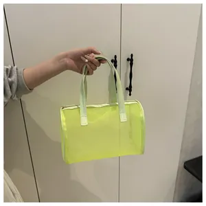 Detailed close-up of a fluorescent neon mesh cosmetic bag with metallic zipper and handles