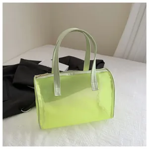 Detailed macro view of a neon yellow mesh handbag with metal zipper and white piping