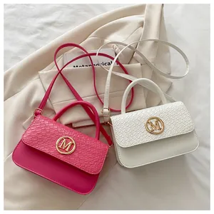Détail de sacs bandoulière fuchsia et blanc avec texture tressée et boucles dorées M