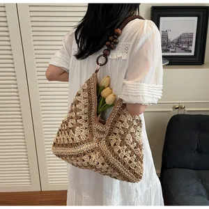 Detailed close-up of the hand-woven texture and stylish wooden bead shoulder strap