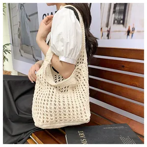 Detail of hand-woven cream hollow tote bag showing intricate crochet texture and pattern