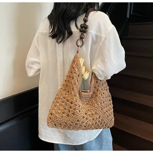 Detail of woven tote bag with wooden bead straps and floral crochet texture