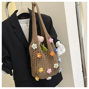 Detailed close-up of brown hollow crochet tote bag with colorful 3D knitted flowers