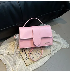 Detailed shot of pink PU leather bag featuring elegant white lace and pearl charm detail