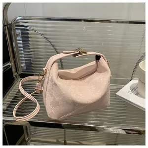 Detail of pink snake pattern mini handbag with gold metal hardware and textured leather