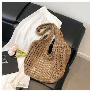 Detail of a brown crochet hollow-out tote bag with woven texture for beach vacation