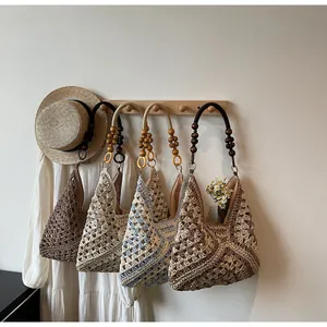 Detail of woven tote bags with retro wooden beads and colorful crochet patterns