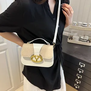 White faux leather and straw patchwork crossbody bag with gold oval buckle and strap