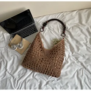 Detail of hand-woven crochet tote with dark brown wooden beads and textured hollow pattern