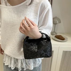 Elegant black snakeskin pattern top-handle small square bag with textured finish